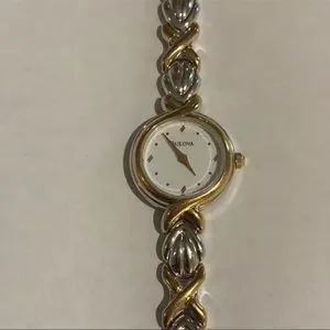 Bulova watch 
Delicate white faced watch with woven bracelet 
6 3/4 
1/4 width Bulova Phantom Watch – Michaels Jewelers main image 2